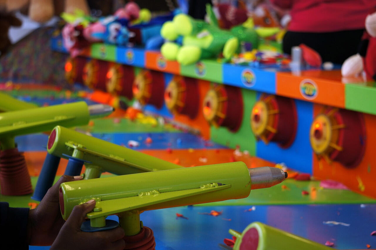 Photo of a water gun game at a carnival.